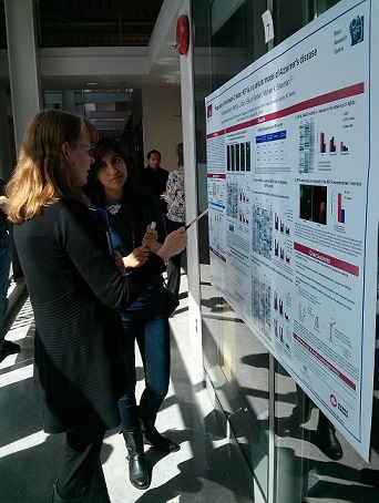 Student discussing their poster with a faculty judge